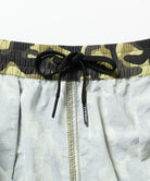 Inside view of the olive camo Gramicci Nylon Reef Shorts with drawstring against a light-tone background.