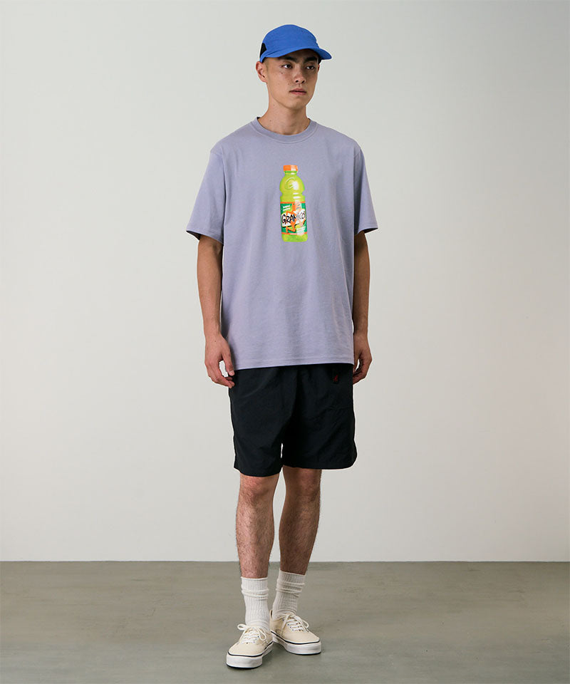 Model wearing black Gramicci Nylon Packable G-Shorts and a lavender shirt on a light-tone background.