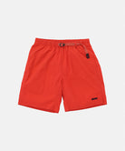 Burnt orange Gramicci Nylon Packable G-Shorts with a belt against a light-tone background.
