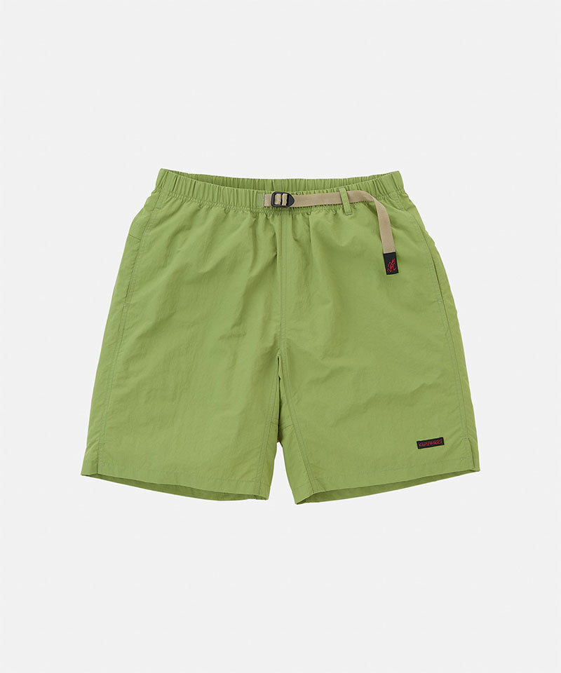 Jade green Gramicci Nylon Packable G-Shorts with a belt against a light-tone background.