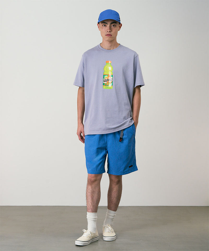 Model wearing marine colored Gramicci Nylon Packable G-Shorts and a lavender shirt on a light-tone background.