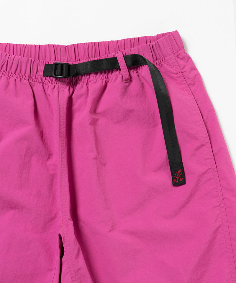 Close-up view of bright plum colored Gramicci Nylon Packable G-Short on a light-tone background.
