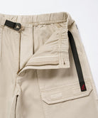 Close-up view of sand pigment Gramicci EQT Pant on a light-tone background.
