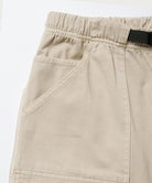 Close-up view of sand pigment Gramicci EQT Pant pocket detail on a light-tone background.