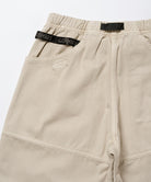 Back view close-up of sand pigment Gramicci EQT Pant on a light-tone background.
