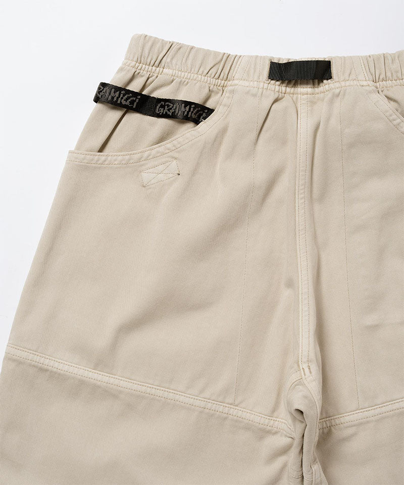 Back view close-up of sand pigment Gramicci EQT Pant on a light-tone background.