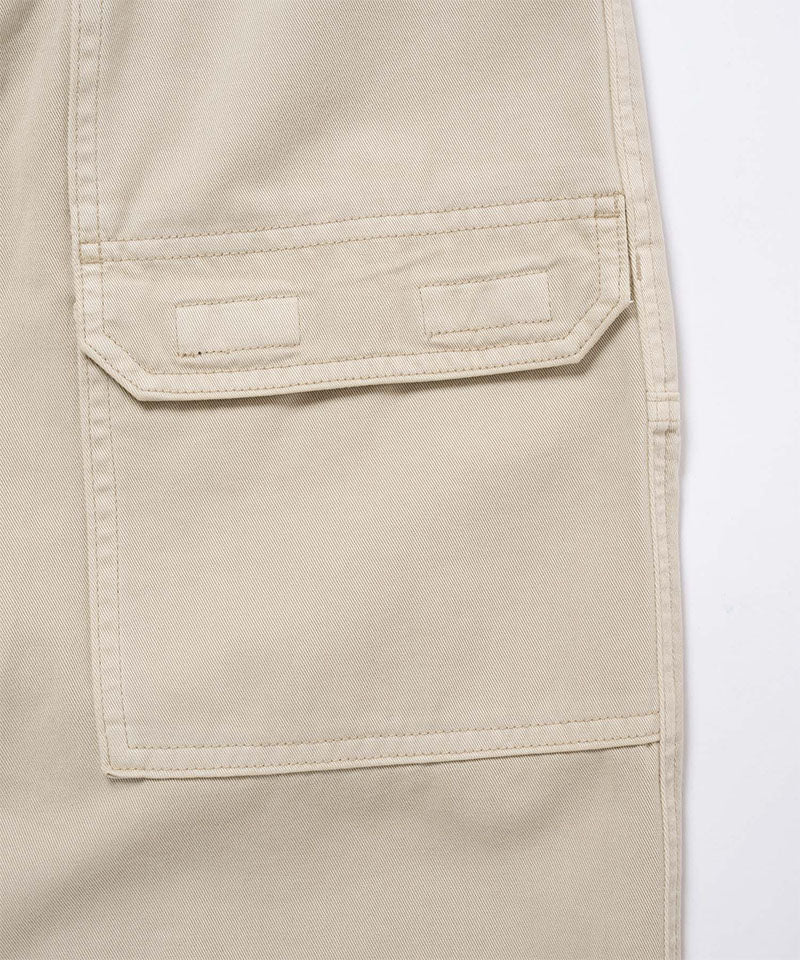 Close-up view of sand pigment Gramicci EQT Pant pocket detail on a light-tone background.