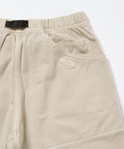 Back view close-up of sand pigment Gramicci EQT Pant on a light-tone background.