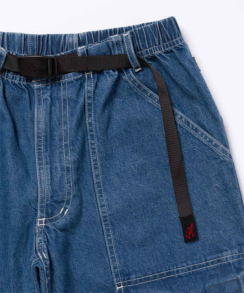 Close-up view of light wash colored Gramicci Denim EQT Pant on a light-tone background.