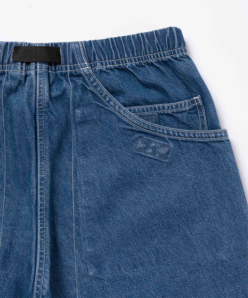 Back view of light wash colored Gramicci Denim EQT Pant on a light-tone background.