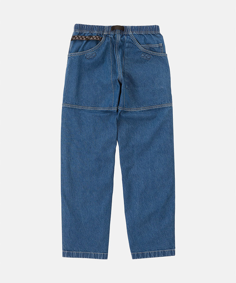 Back view of light wash colored Gramicci Denim EQT Pant on a light-tone background.