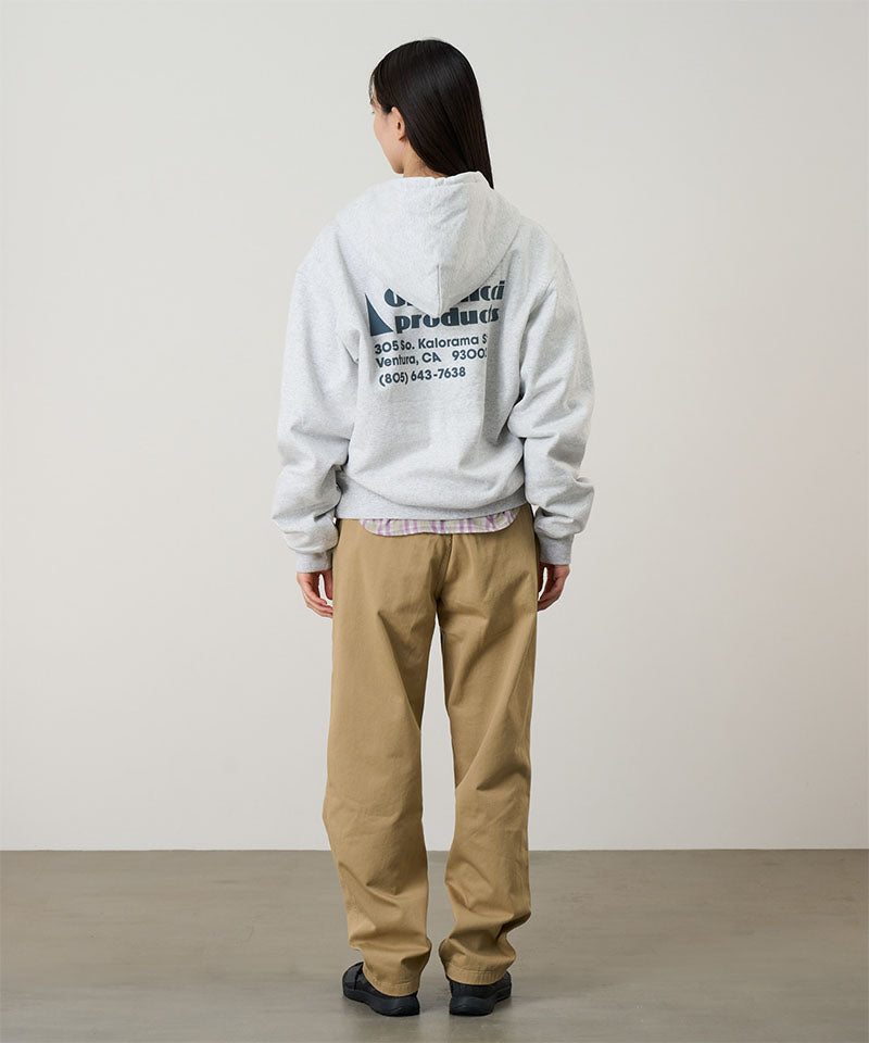 Back view of a model wearing a heather ash Gramicci G-Sail Zip Hooded Sweatshirt with a teal graphic and khaki pants on a light-tone background.