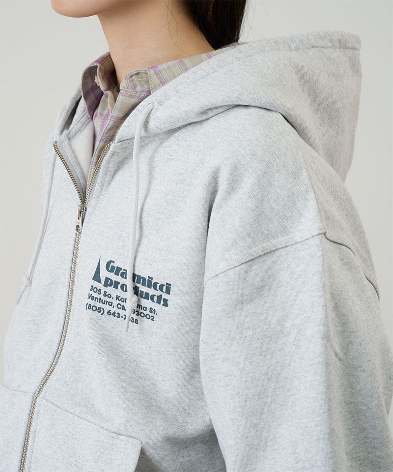 Model wearing a Gramicci heather ash G-Sail Zip Hooded Sweatshirt with a teal graphic against a light-tone background.