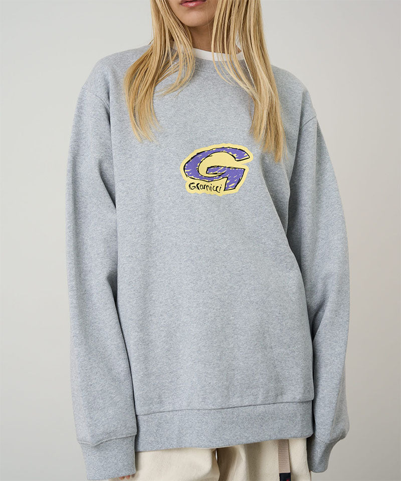 Model wearing a Gramicci heather grey G-Scribble Sweatshirt with purple and yellow graphic against a light tone background.