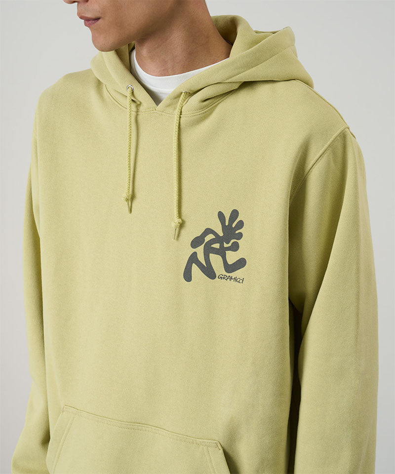 Model wearing a Gramicci lime Running Man Hooded Sweatshirt with grey running man graphic against a light tone background.