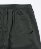 Close-up view of shadow colored Gramicci Swell Pant back pocket detail on a light-tone background.