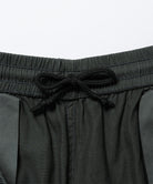 Close-up inside view of shadow colored Gramicci Swell Pant with drawstring on a light-tone background.