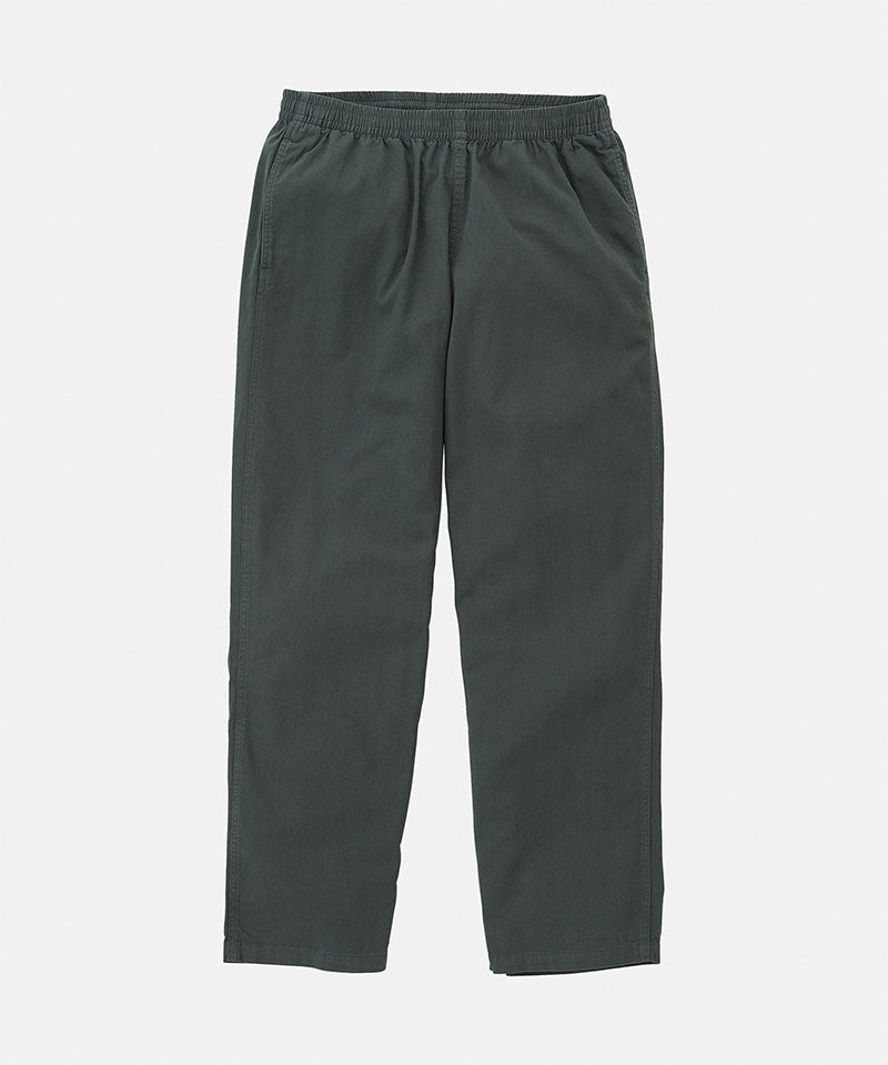 Shadow colored Gramicci  Swell Pant with a belt against a light-tone background.