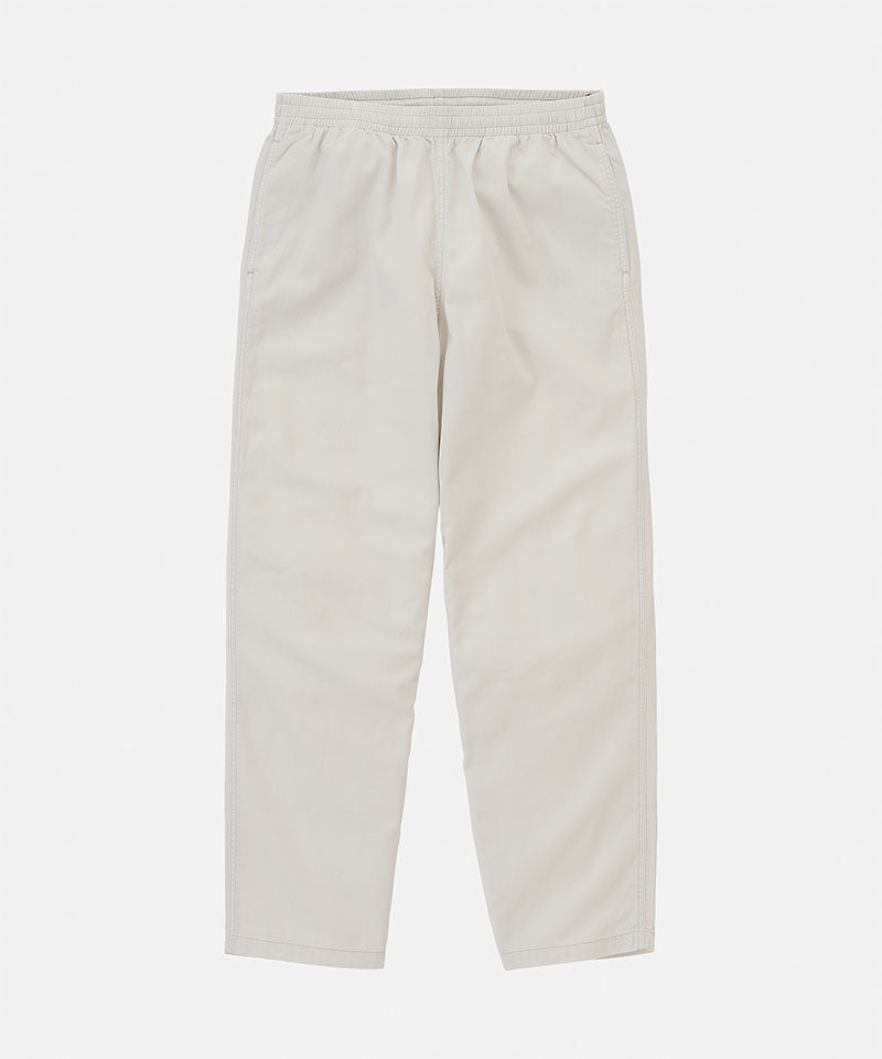Stone colored Gramicci Swell Pant with a stretchy waistband against a light-tone background.