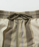 Close-up inside view of shadow plaid colored Gramicci Swell Short Shadow Plaid with drawstring detail on a light-tone background.
