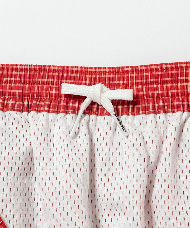 Inside view of red Gramicci Grid Swim Short showing waistband detail on a light-tone background.