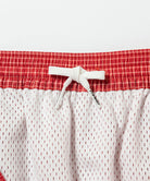 Inside view of red Gramicci Grid Swim Short showing waistband detail on a light-tone background.