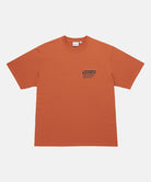 Gramicci orange G-Sail Tee with black graphic against a light-tone background.