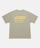 Back view of a Gramicci beige G-Sail Tee with a yellow graphic against a light-tone background.
