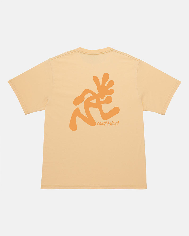 Back view of a Gramicci mango colored Running Man Tee with dark mango colored graphic against a light-tone background.