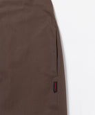 Close-up of Gramicci Women's Woven Milton Dress in the color walnut against a light-tone background.
