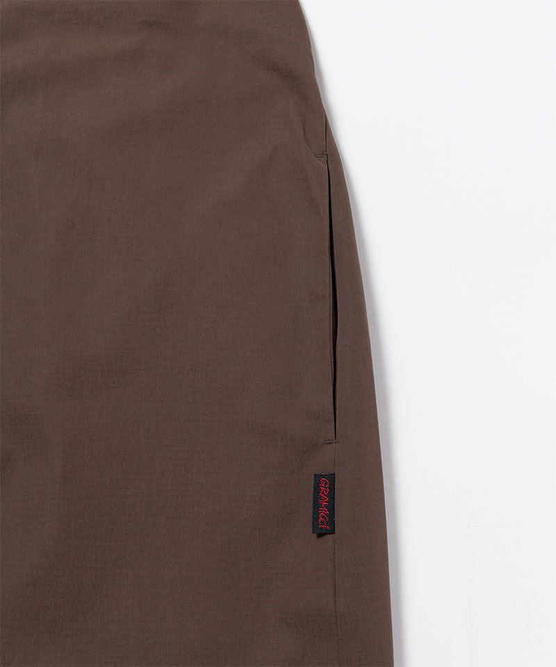 Close-up of Gramicci Women's Woven Milton Dress in the color walnut against a light-tone background.
