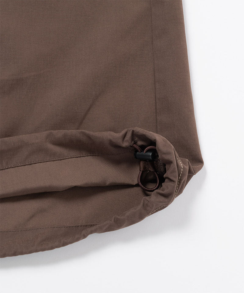 Close-up of Gramicci Women's Woven Milton Dress  with a drawstring in the color walnut against a light-tone background.
