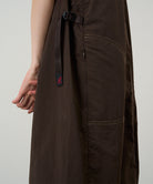 Model wearing a chocolate colored Gramicci Nylon Dress on a light-tone background.