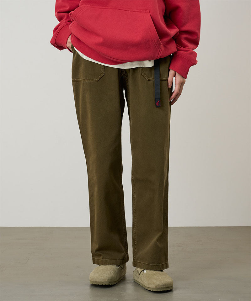 Model wearing bark pigment colored Gramicci Women's Brooks Pants and a red hoodie on a light-tone background.