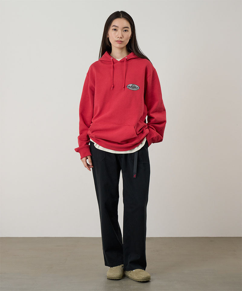 Model wearing black Gramicci Women's Brooks Pants and a red hoodie on a light-tone background.