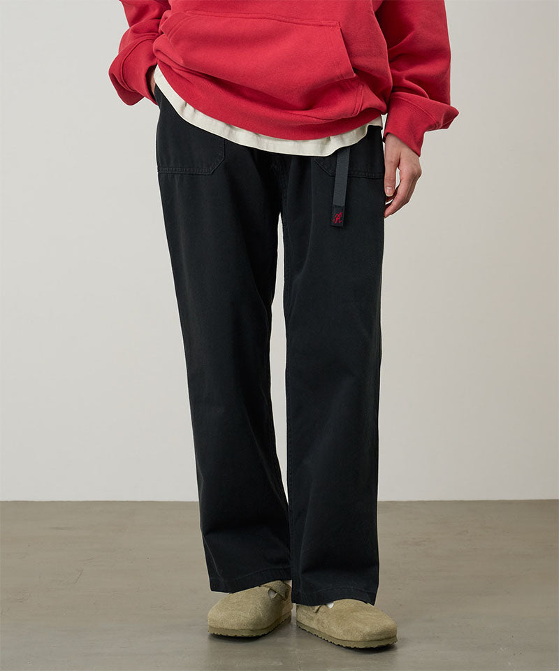 Model wearing black Gramicci Women's Brooks Pants and a red hoodie on a light-tone background.