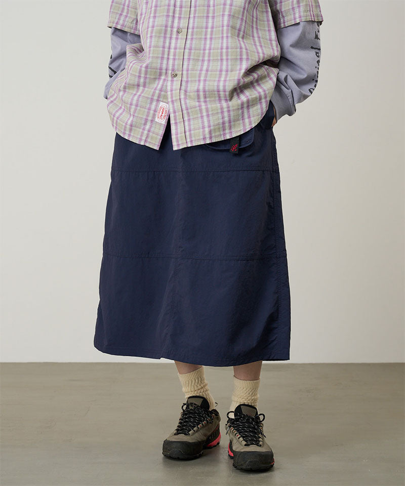 Model wearing a Gramicci british navy Nylon Utility Skirt against a light-tone background.
