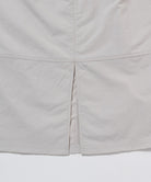 Gramicci ecru colored Nylon Utility Skirt hem detail against a light-tone background.