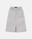 Back view of a Gramicci ecru colored Nylon Utility Skirt against a light-tone background.