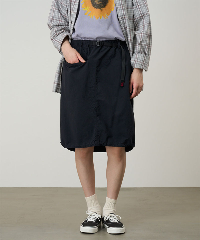 Model wearing a Gramicci black Nylon Packable Midi Skirt against a light-tone background.
