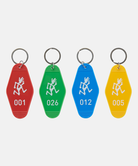 Four colorful Gramicci Hotel Keychains with numbers and a running man on a white background