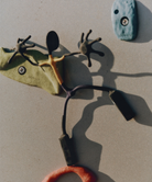 Close-up of a unique, abstract sculpture on a rock climbing wall.