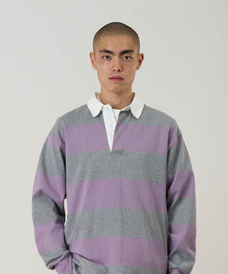 Model wearing a Gramicci heather and purple stripped Gramicci Langdon Rugby Shirt against a light-tone background.